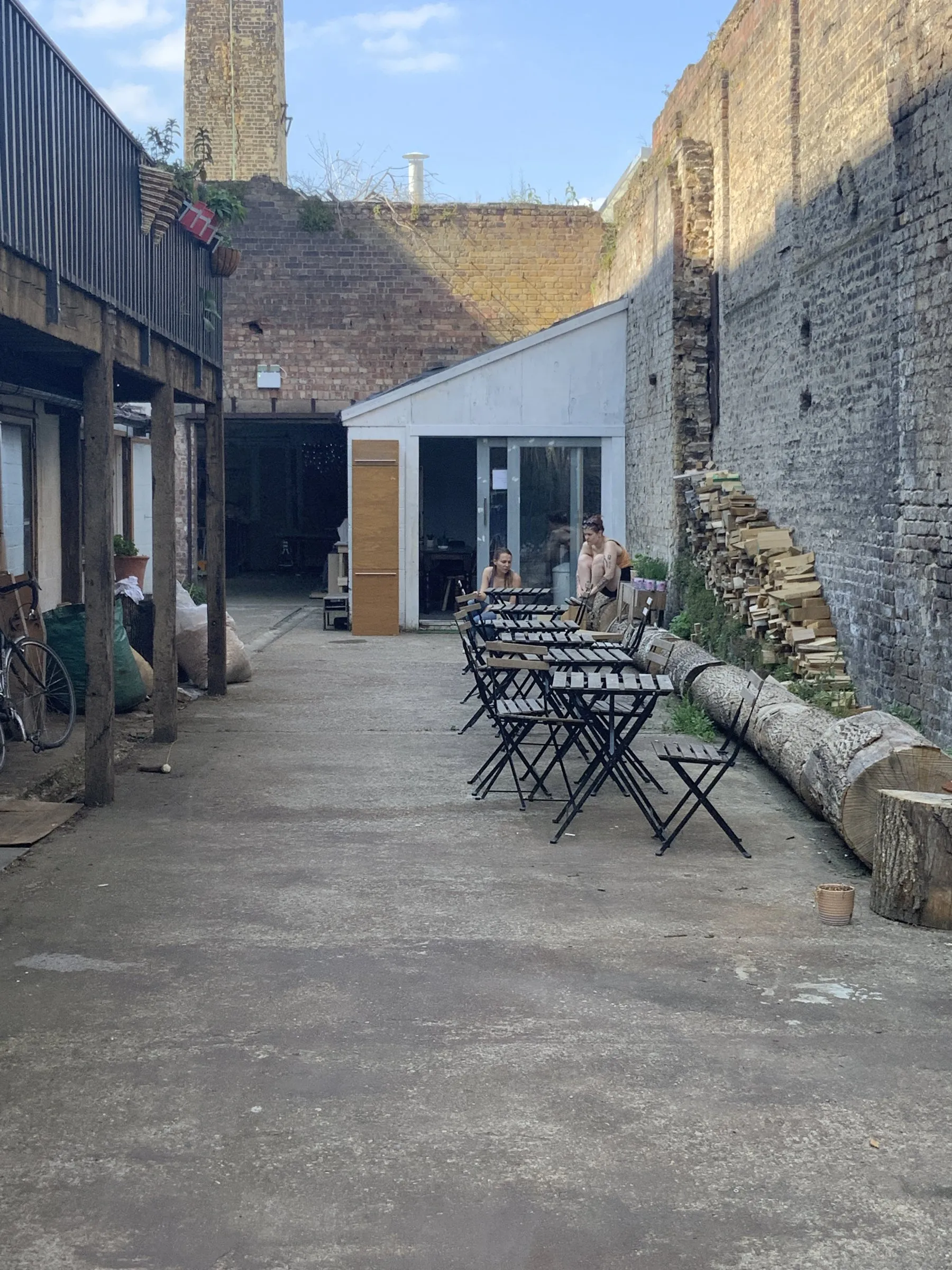 The yard with its tables and the old chimney