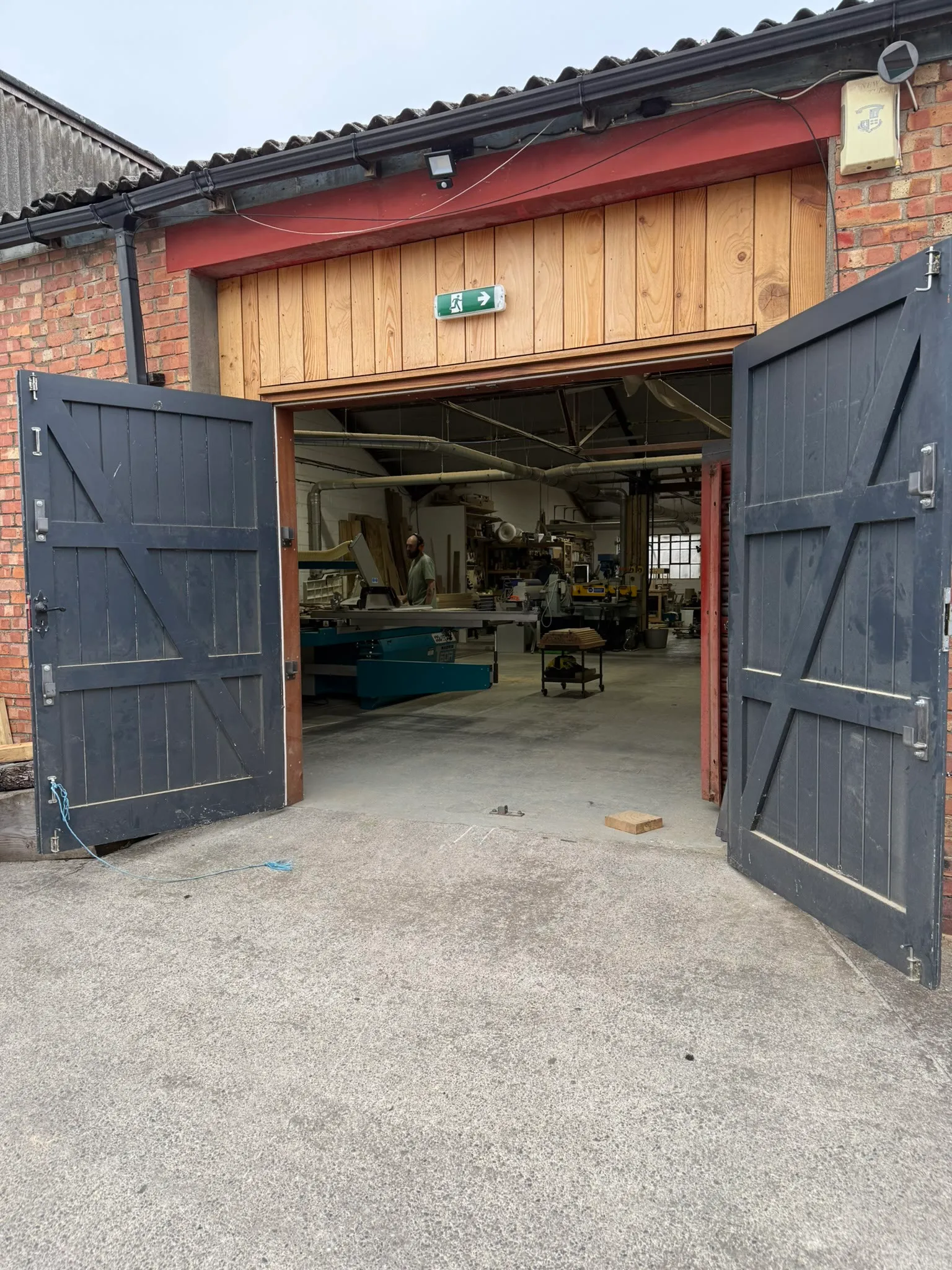 The workshop doors open onto the yard