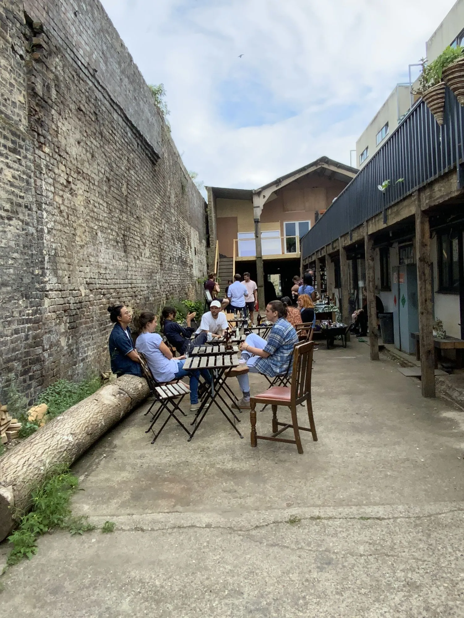 Members at the tables in the courtyard at Hone Limehouse