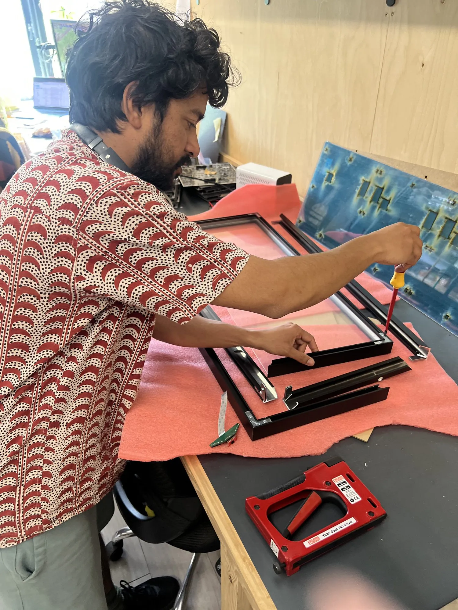 Dhruv Kumar assembling an LED panel at his bench in the makerspace
