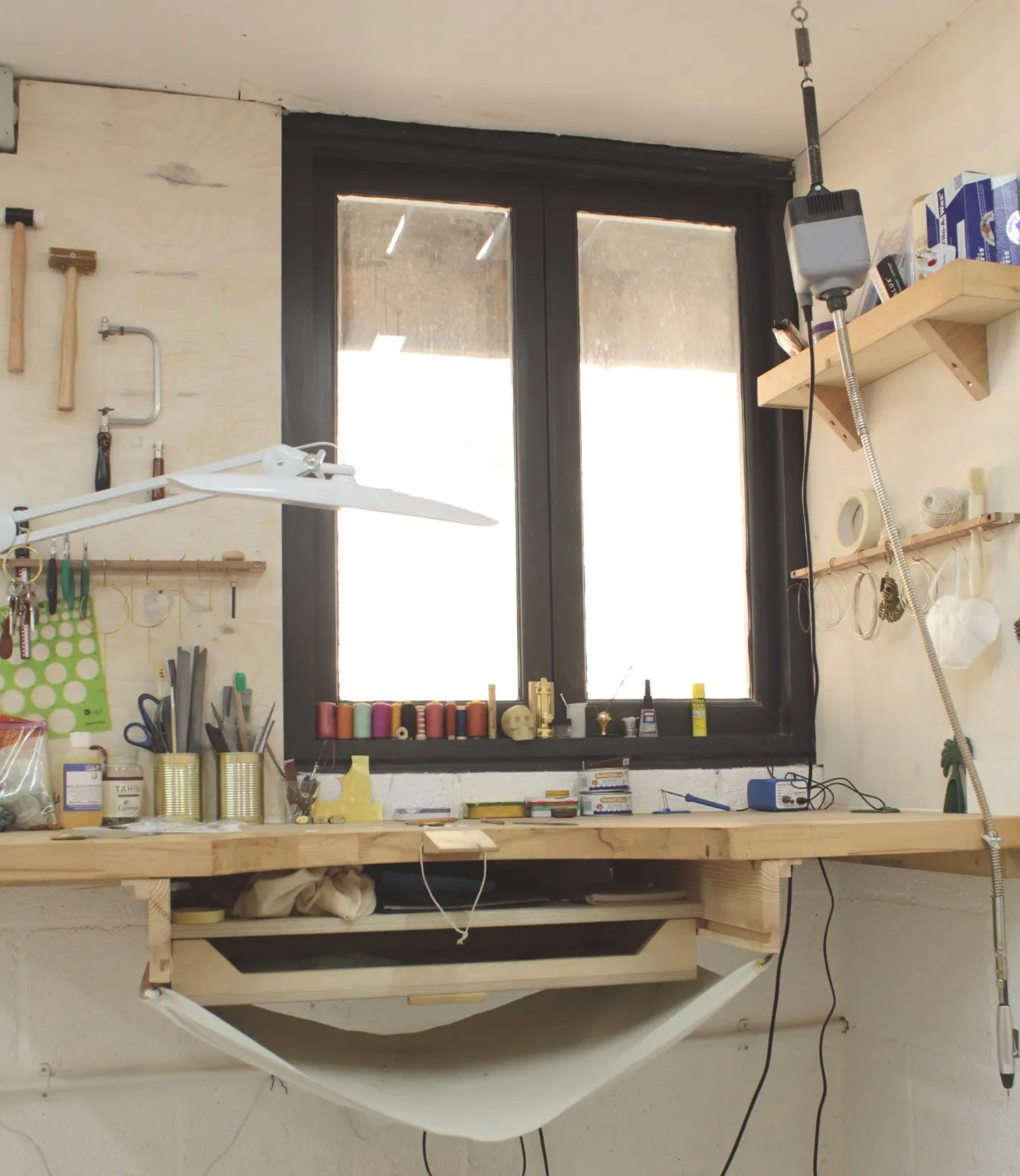 A jewellery bench by the window in the jewellery workshop