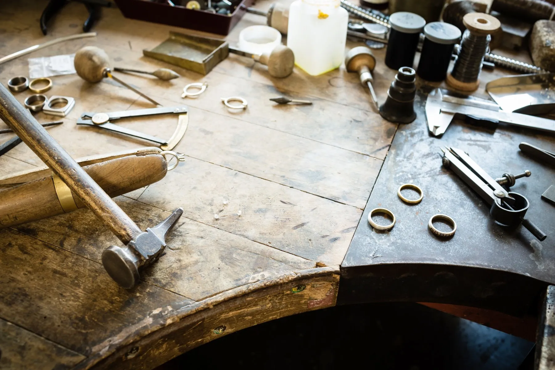 Rings and hand tools on a jeweller’s bench peg