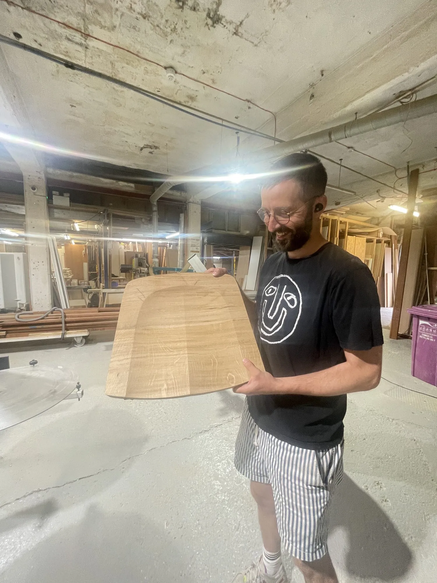 Simon holding a curved plywood shell