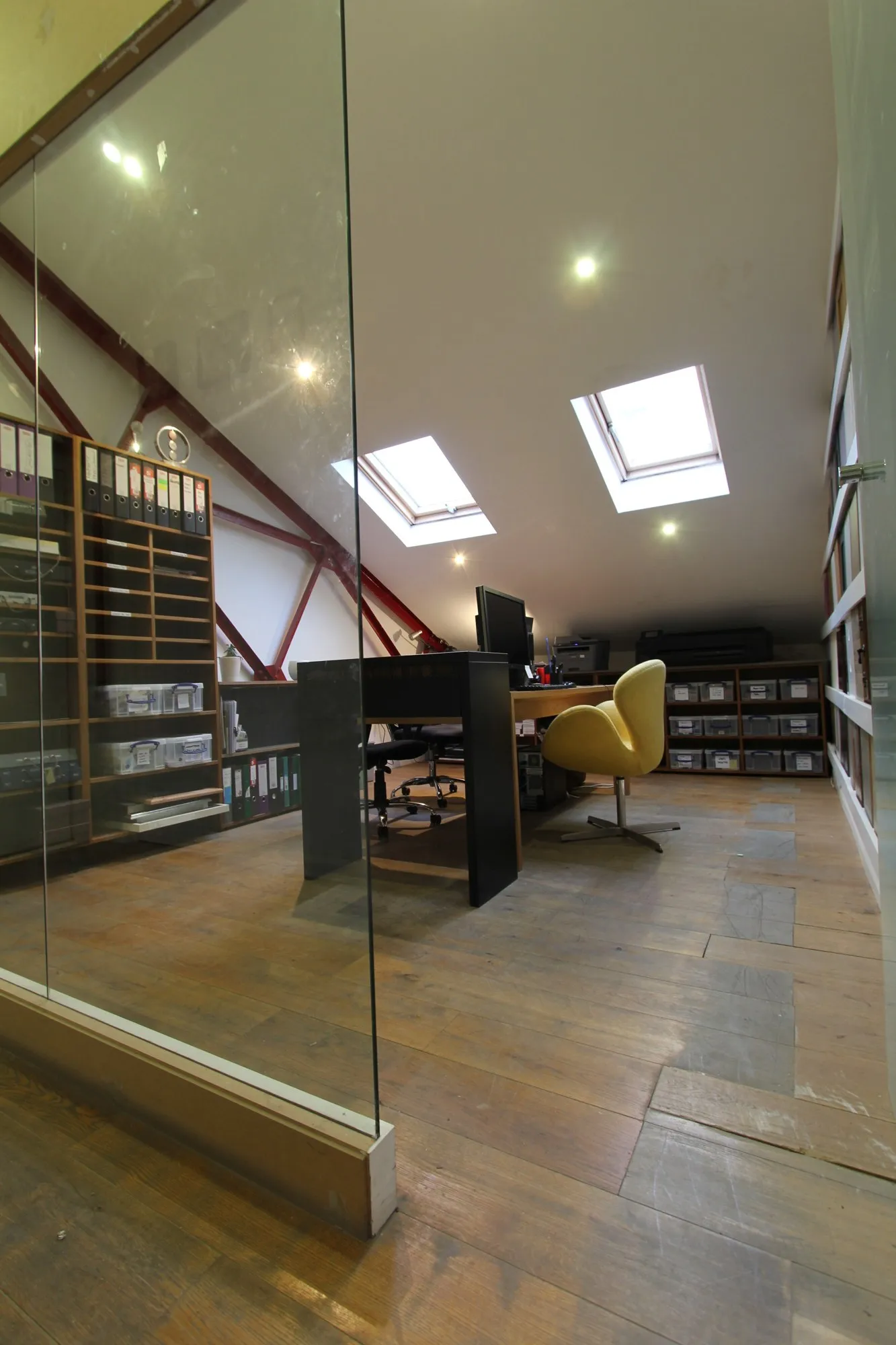 A material library on shelves under a skylight, in a studio at Hone Limehouse