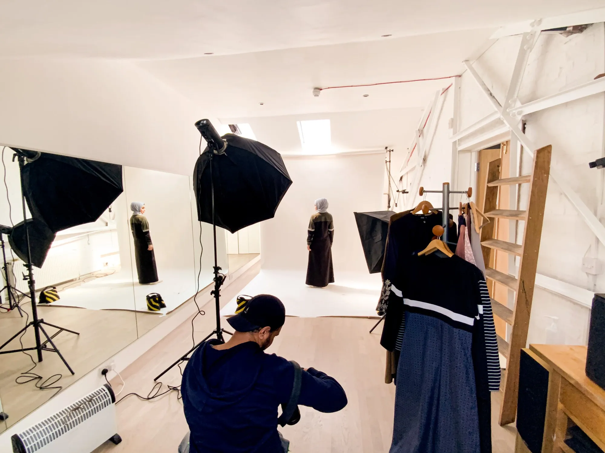 A photo shoot with lights and a rail of clothes, in a studio at Hone Limehouse
