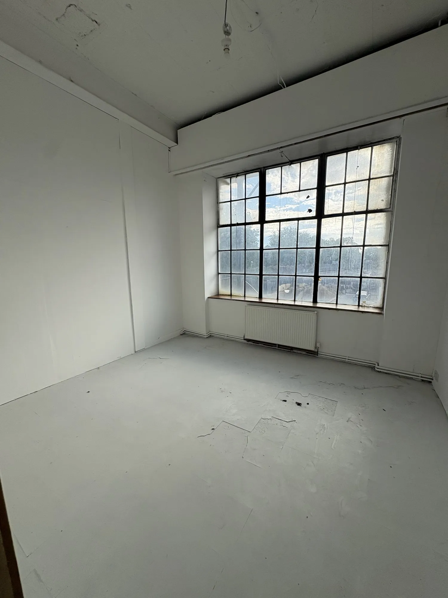 A studio workshop at Hone Tottenham with a huge window, before the fit-out