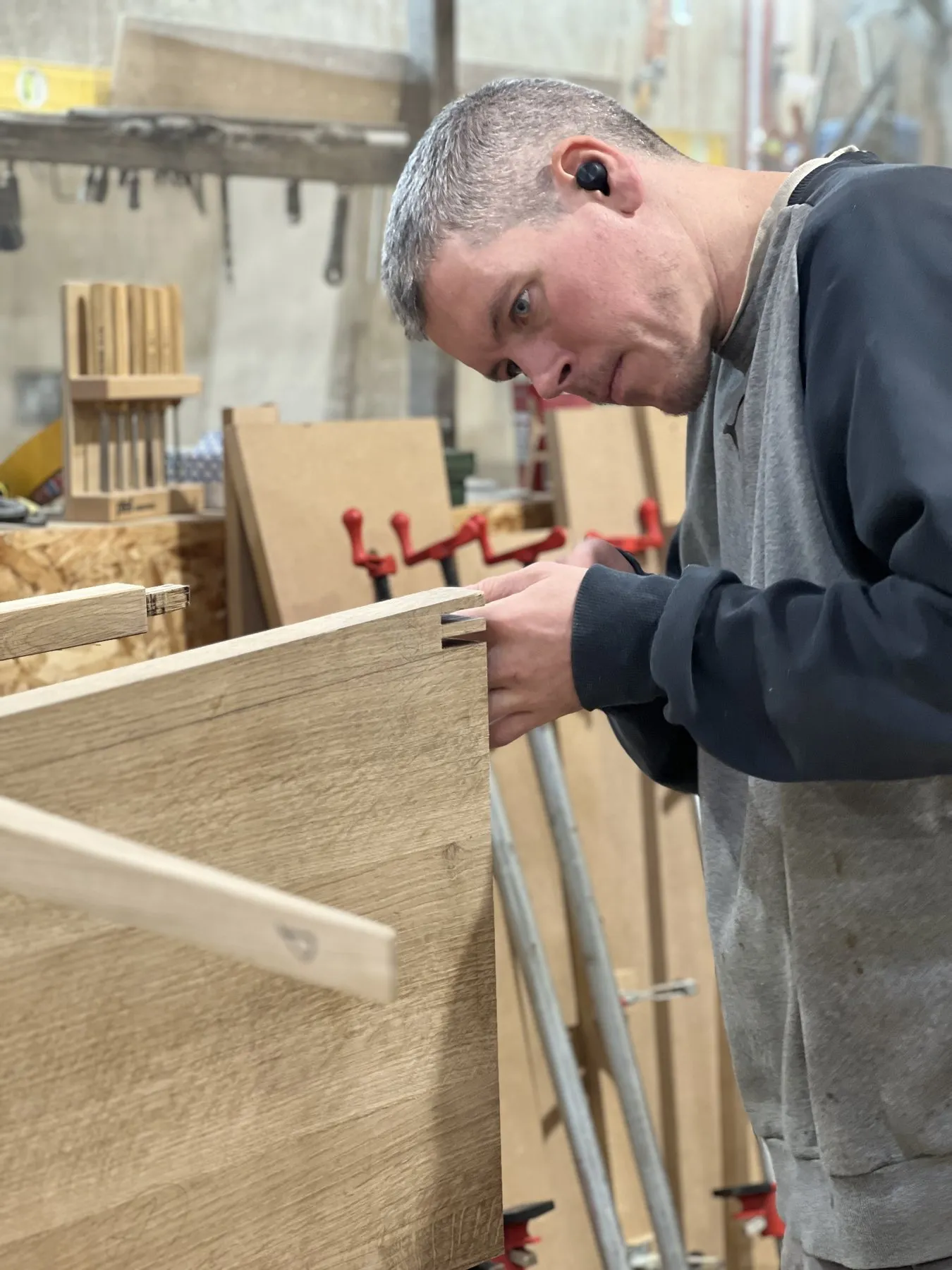 Mike Williams clamping up a cabinet in the woodwork shop