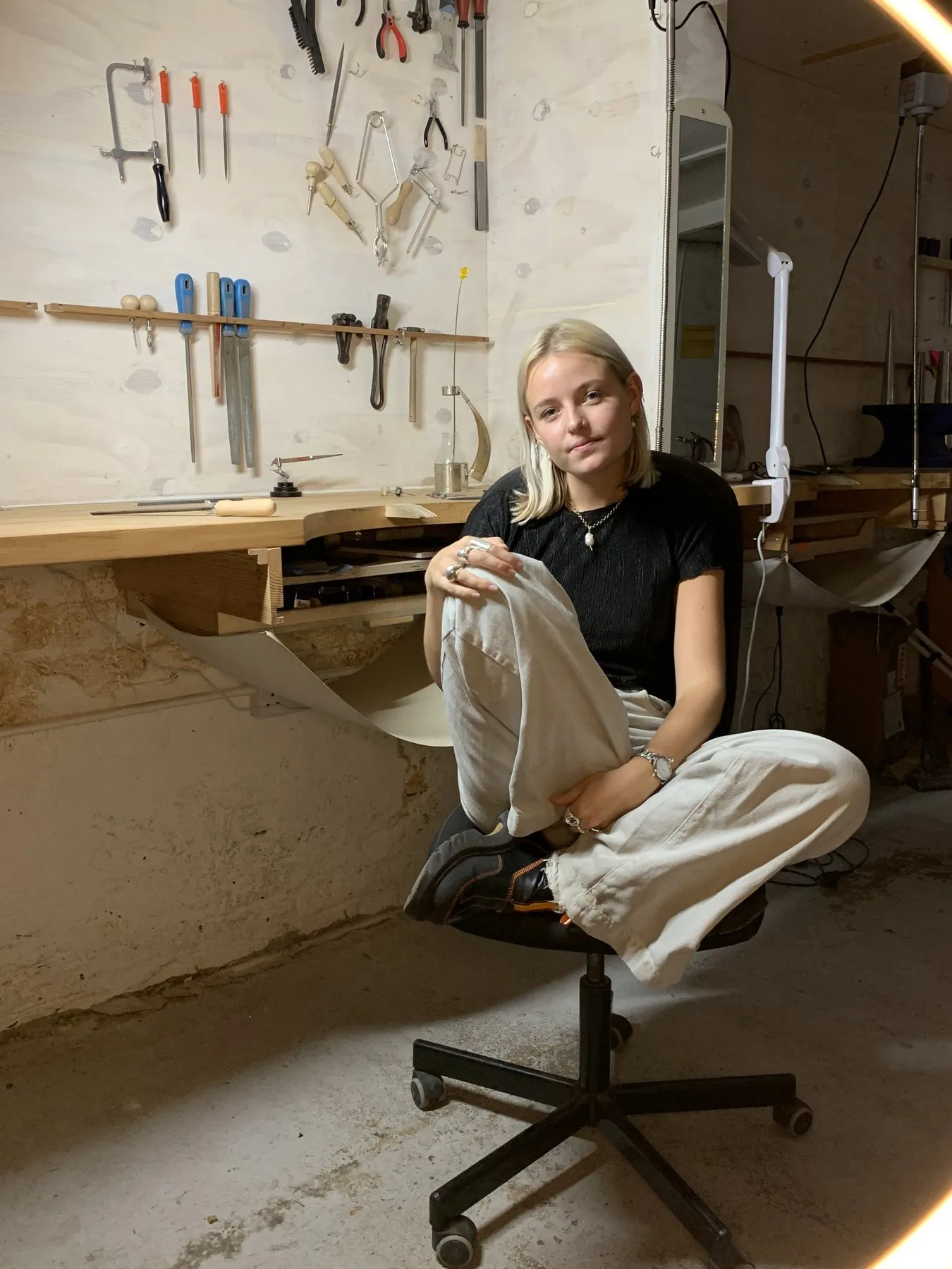 Phoebe at her bench in the jewellery workshop
